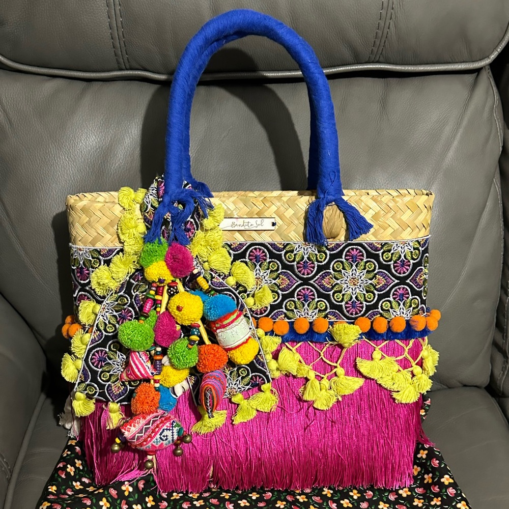 Handmade straw handbag, new with dust bag, vibrant colors, interior is lined.
